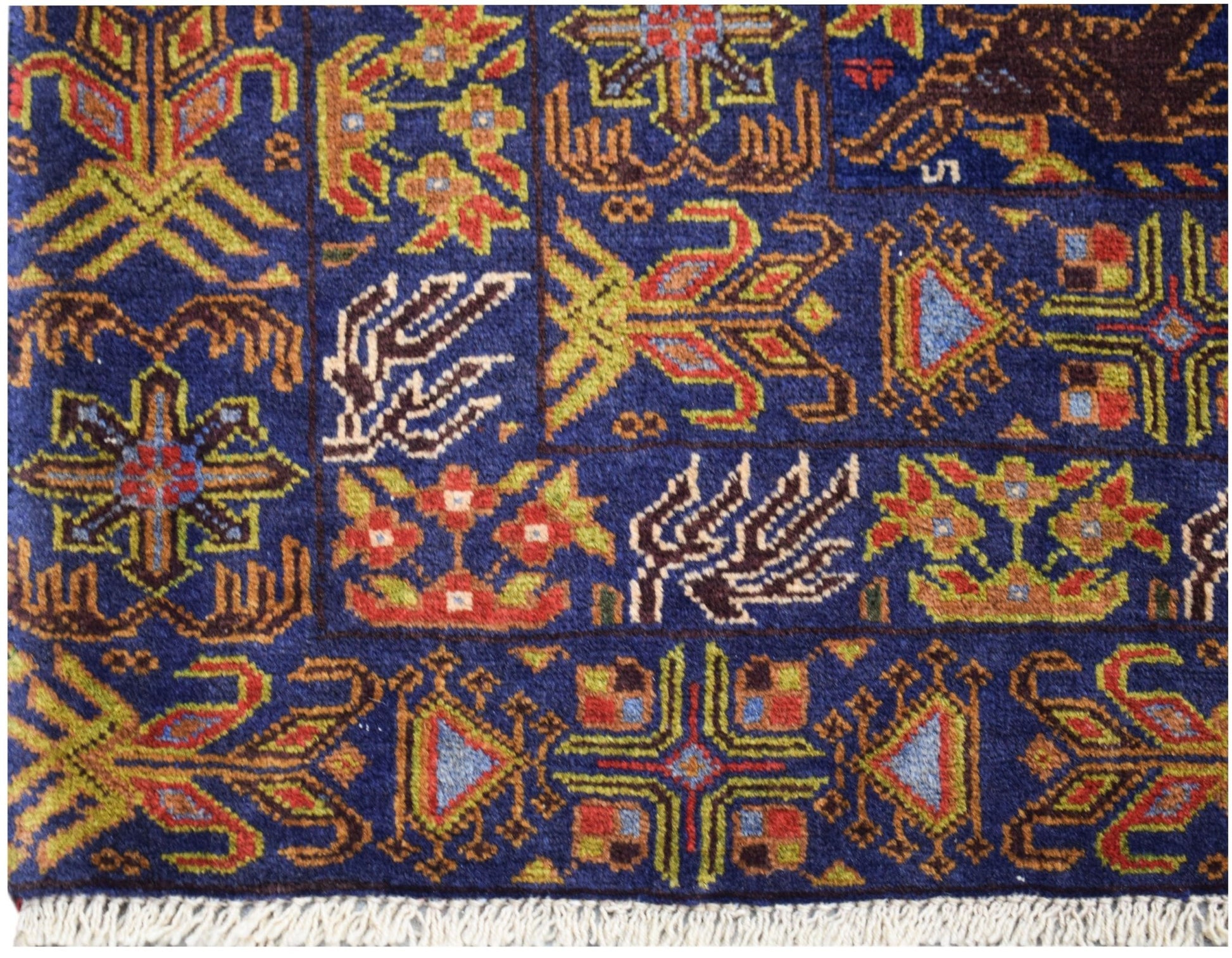 A vintage Afghan Baluch rug featuring a blue field with intricate geometric and floral patterns.
