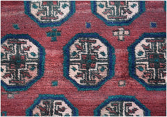 A vintage Afghan Baluch rug featuring repeating geometric octagonal motifs in red, blue, and cream.