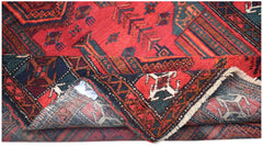 Vintage Afghan Baluch rug with red, green, and blue geometric patterns.