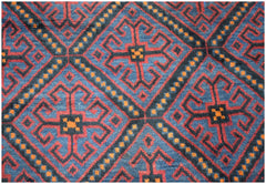 A vintage Afghan Baluch rug featuring a repeating geometric diamond pattern in blue, red, and orange.