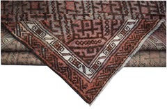 A vintage handmade Afghan Baluch wool rug featuring geometric patterns in brown and muted red.