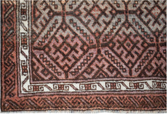 A vintage Afghan Baluch rug featuring a geometric diamond pattern in shades of brown and cream.