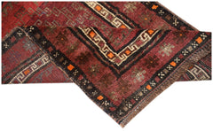 A vintage handmade Afghan Baluch rug featuring geometric patterns in deep red, brown, and ivory.