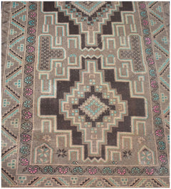 A handmade vintage Afghan Baluch runner featuring geometric diamond patterns in brown and teal.