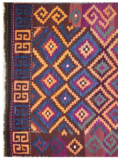 A vintage Afghan Maimana kilim rug featuring a geometric diamond pattern in orange, blue, and purple.