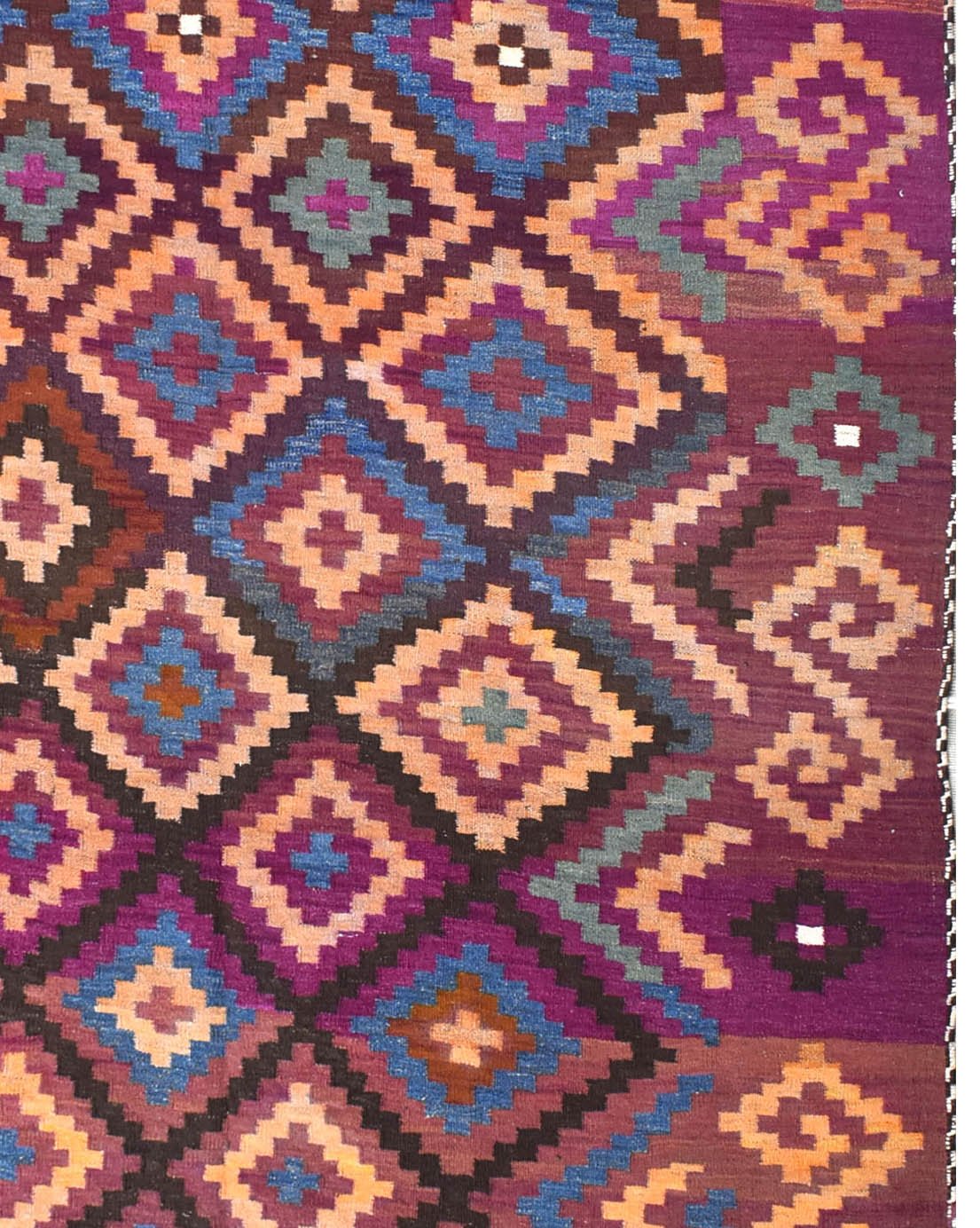 A vintage Afghan Maimana kilim rug featuring a geometric diamond pattern in purple and orange tones.