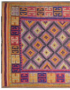 A vintage Afghan Maimana kilim featuring a purple diamond pattern and a geometric border.