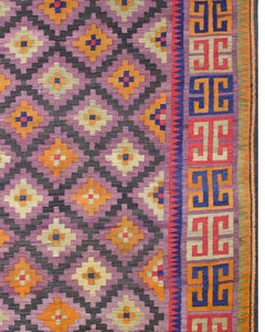 A vintage Afghan Maimana kilim featuring a purple diamond pattern and a geometric border.