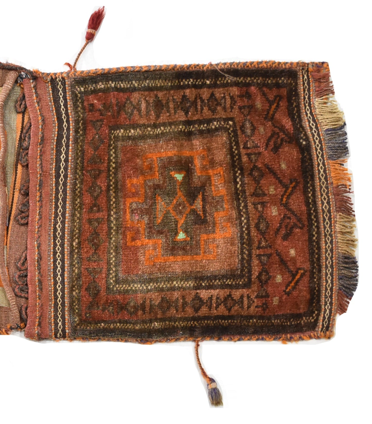 A handmade vintage Afghan wool saddle bag featuring a geometric pattern in earthy red and orange.