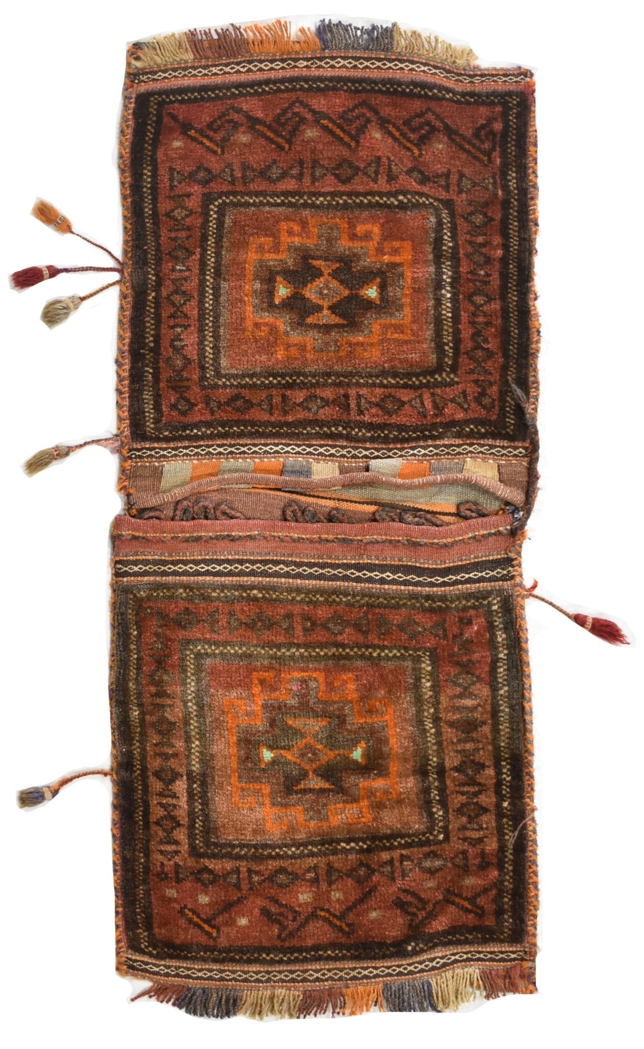 A handmade vintage Afghan wool saddle bag featuring geometric patterns in red and orange tones.