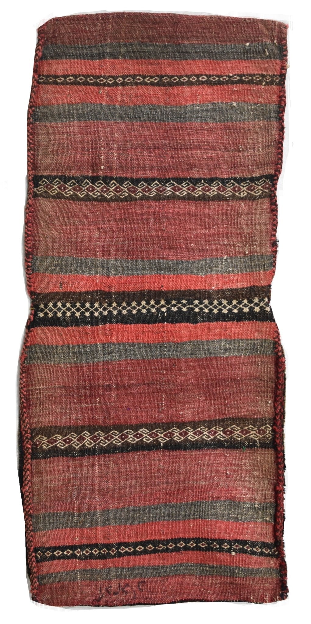 A handmade vintage Afghan wool saddle bag featuring horizontal red and black striped patterns.