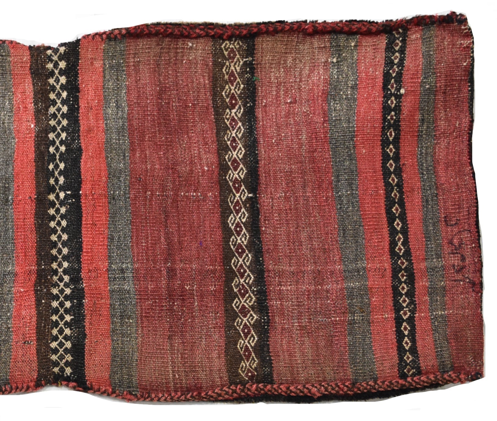 A vintage handmade Afghan wool saddle bag featuring red and grey stripes with geometric patterns.