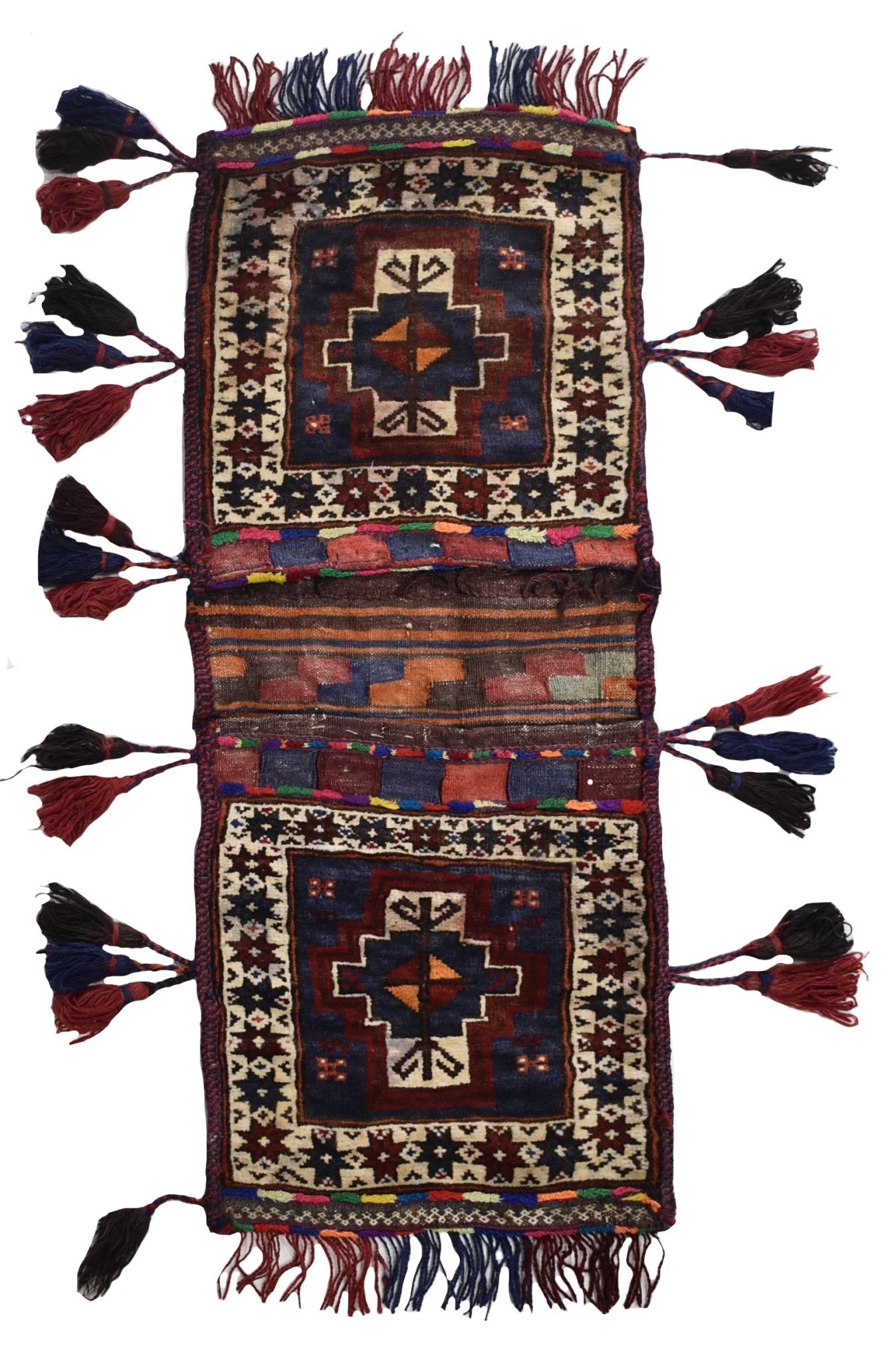 A handmade vintage Afghan wool saddle bag featuring two patterned panels with decorative tassels.