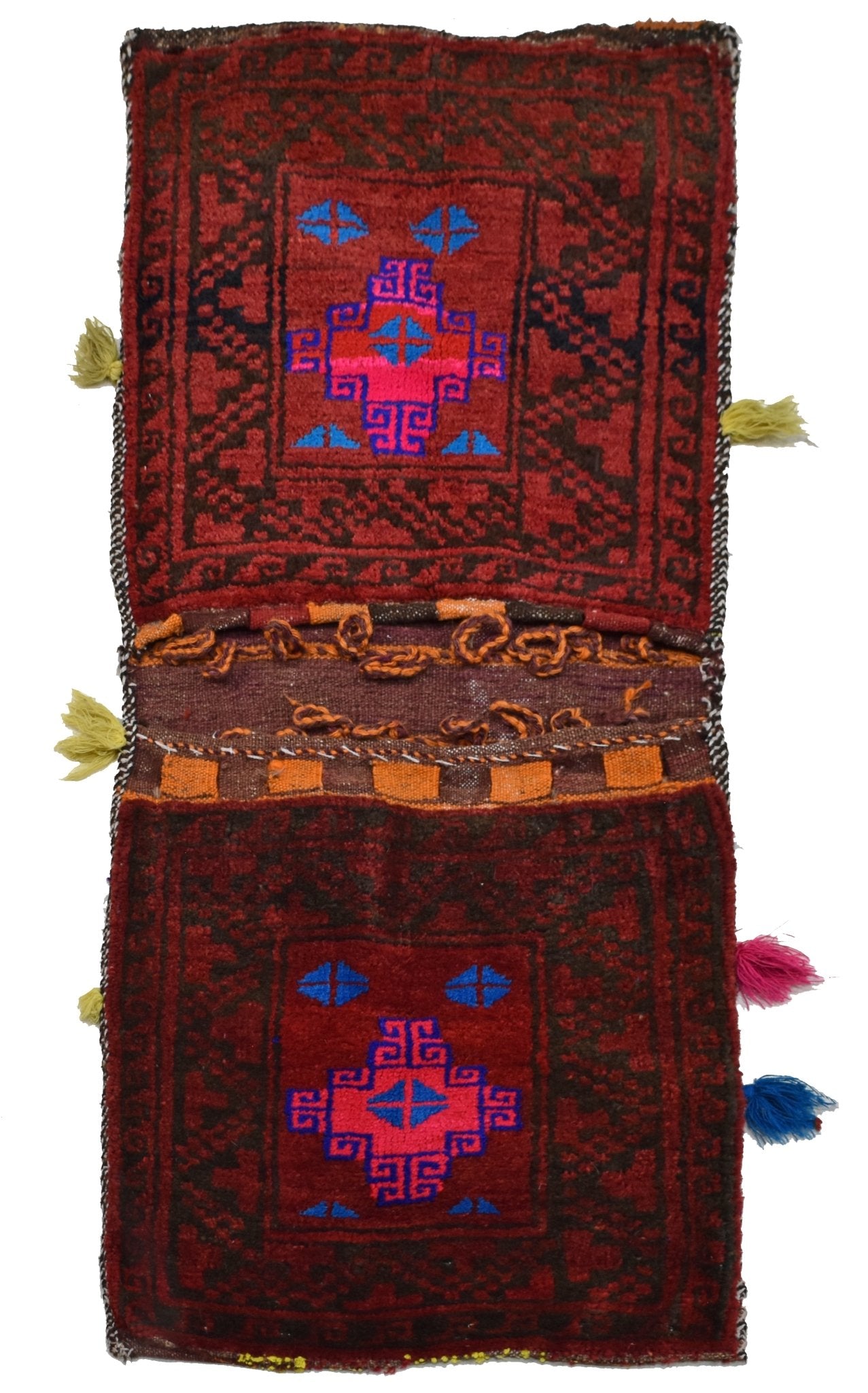 A vintage handmade Afghan wool saddle bag featuring two red panels with geometric blue motifs.