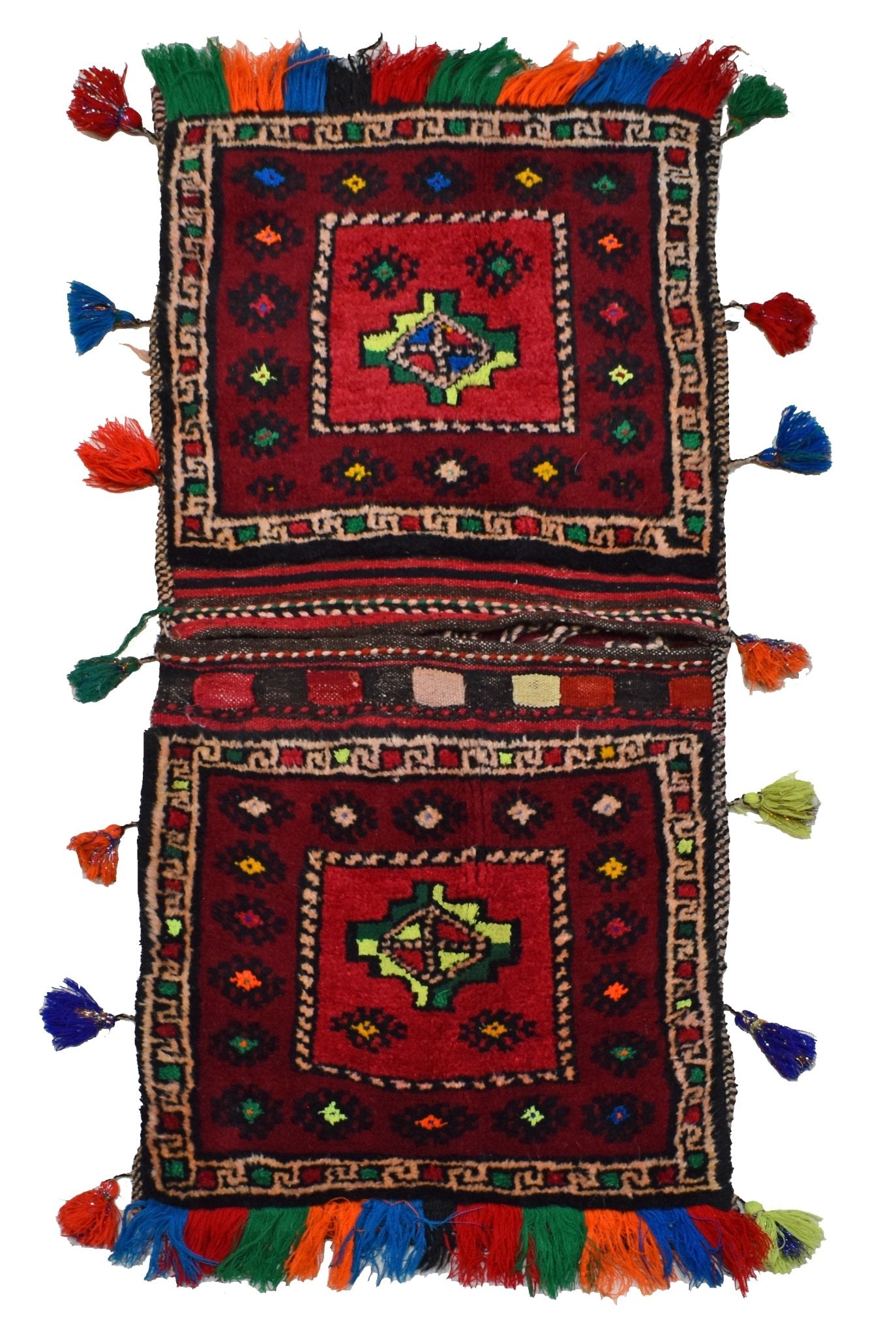 A vintage handmade Afghan wool saddle bag featuring two square panels with geometric patterns and colorful tassels.