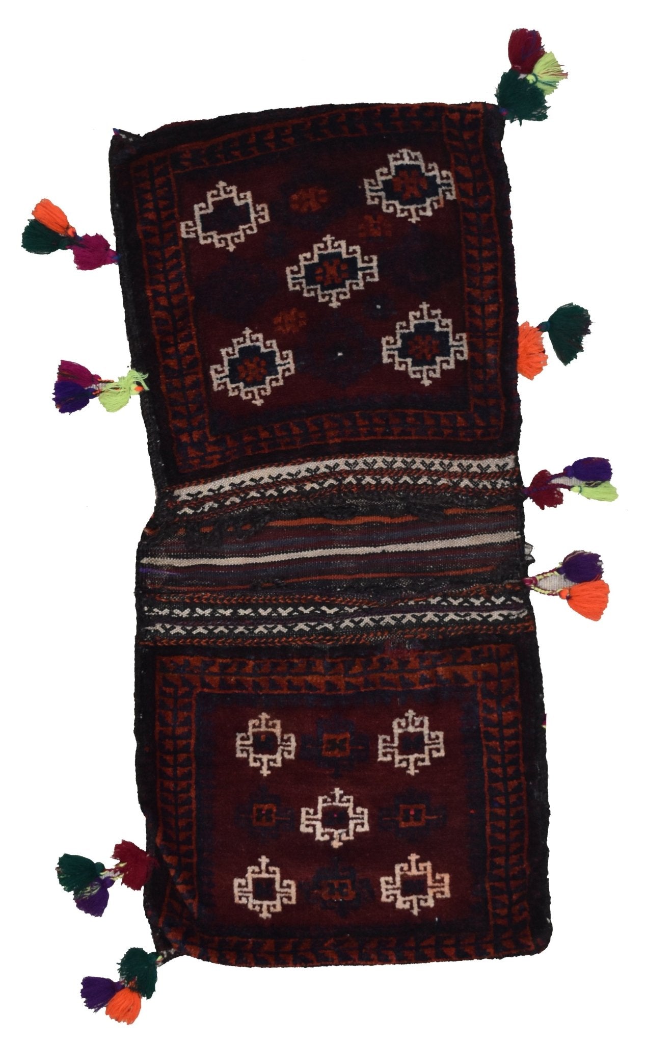 A handmade vintage Afghan wool saddle bag featuring geometric patterns and colorful tassels.