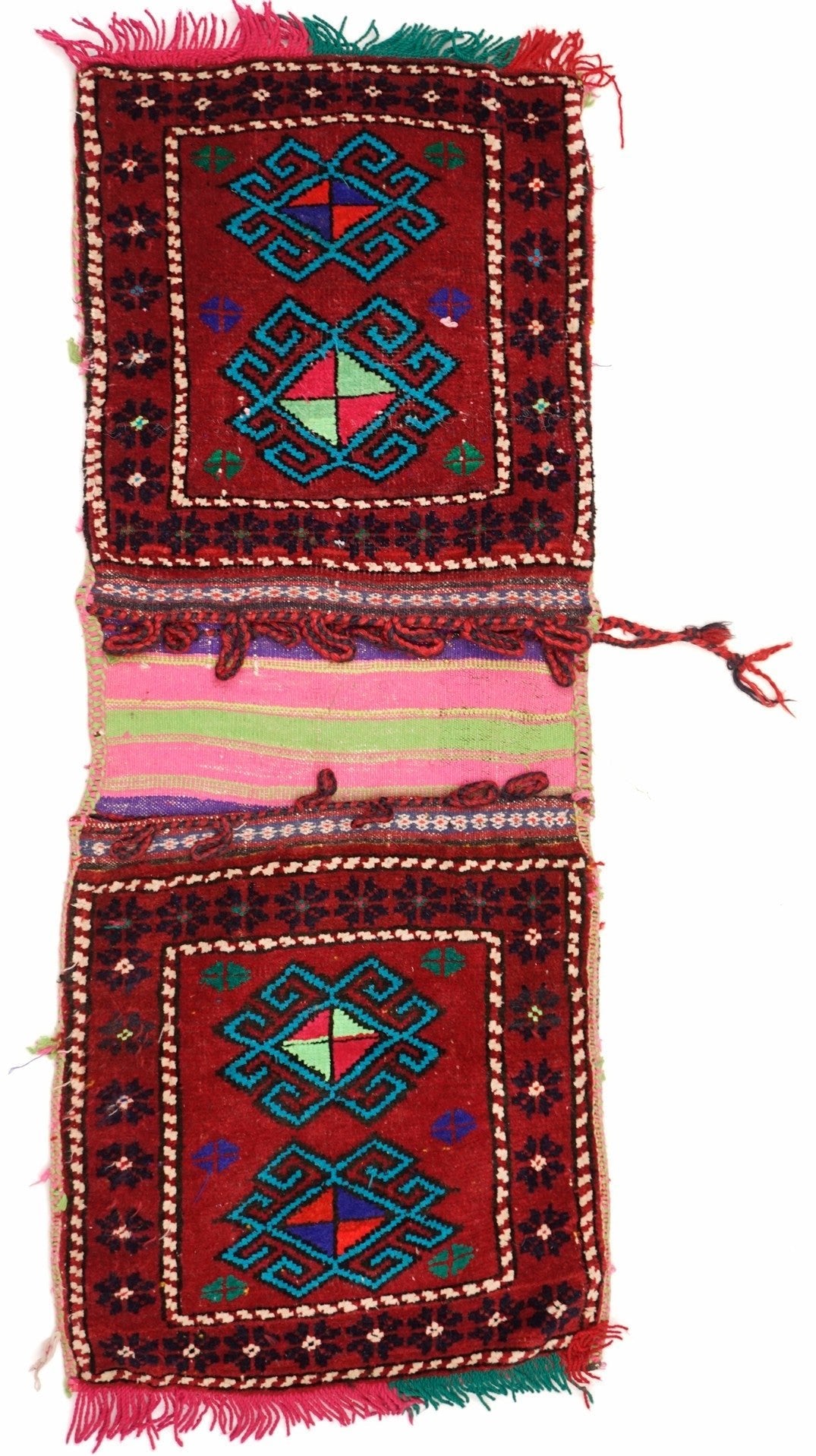 A handmade vintage Afghan wool saddle bag featuring two red panels with geometric motifs.