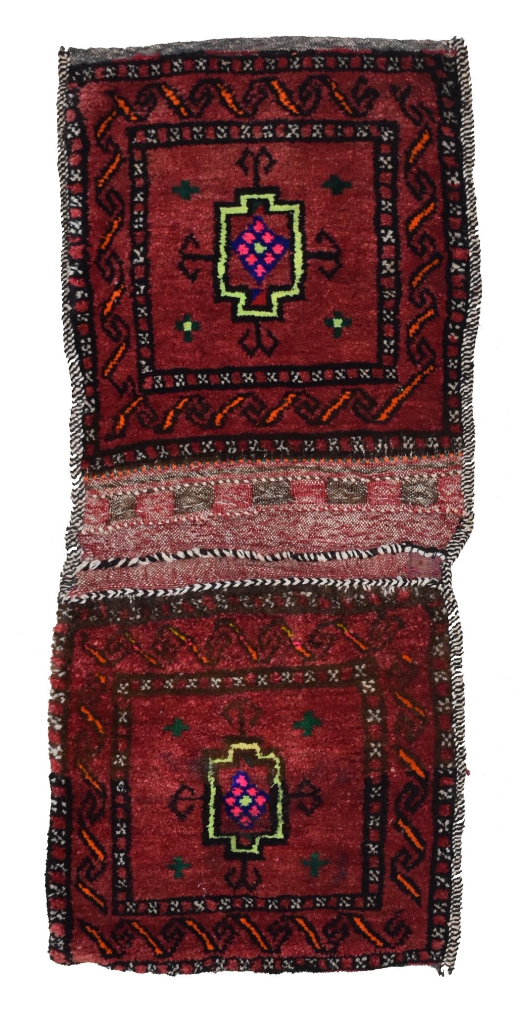 A vintage handmade Afghan wool saddle bag featuring two red panels with geometric motifs.