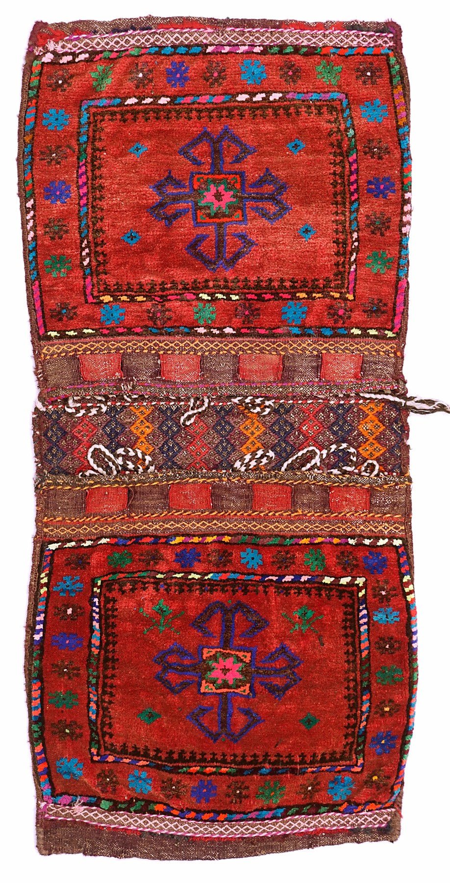 A handmade vintage Afghan wool saddle bag featuring two red panels with blue cross motifs.