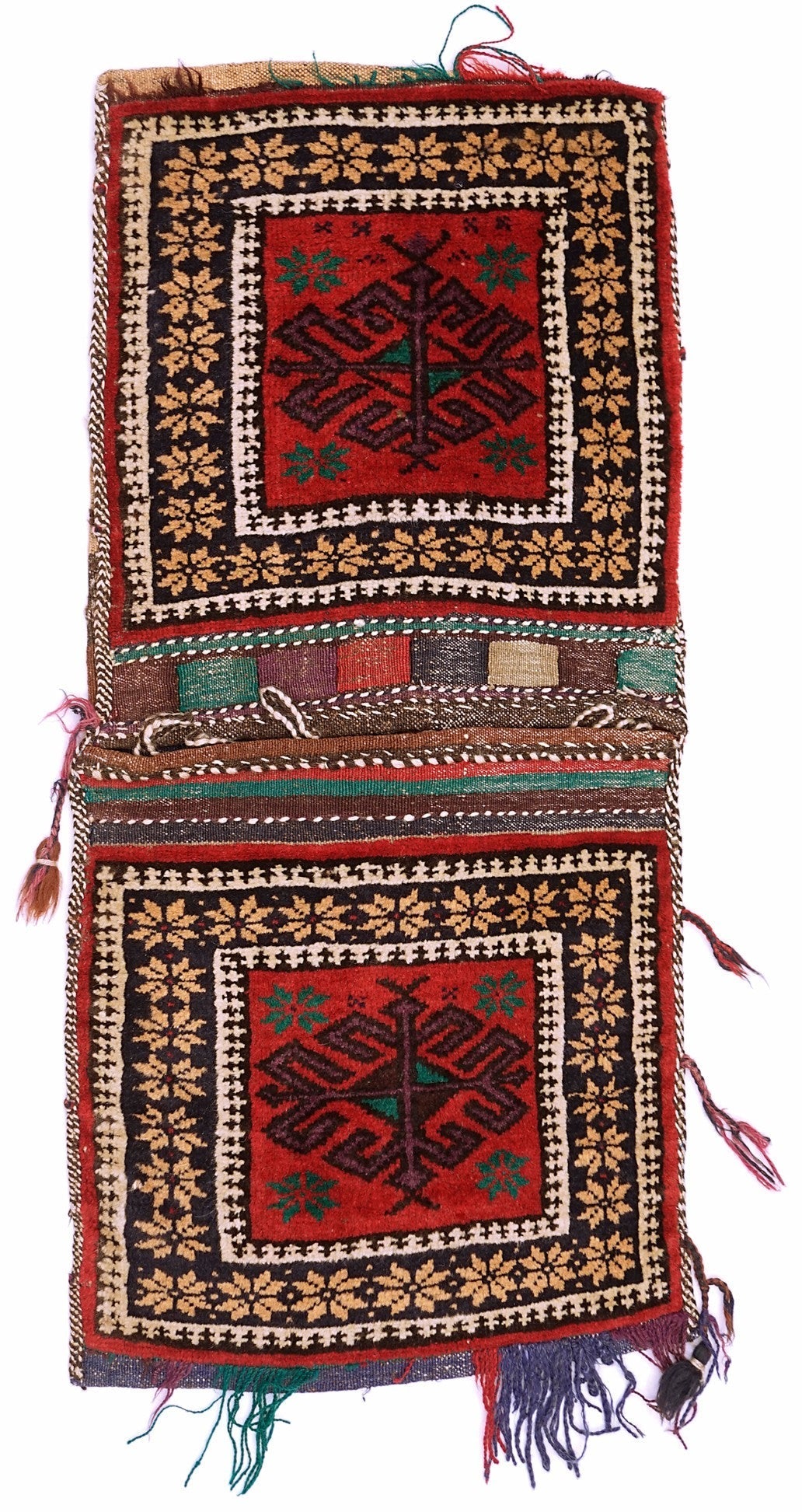 A handmade vintage Afghan wool saddle bag featuring two matching red panels with geometric motifs.