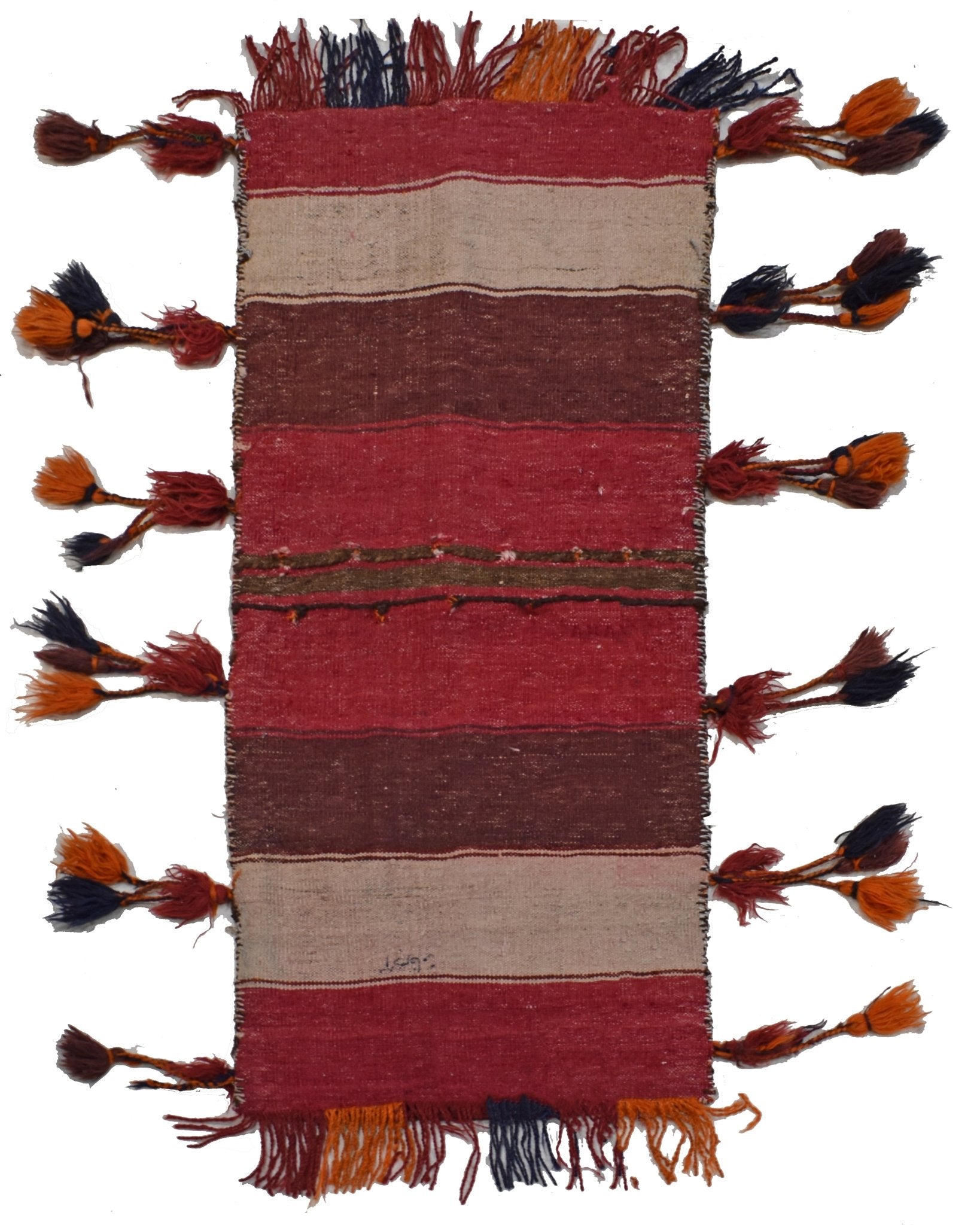 A vintage handmade Afghan wool saddle bag featuring horizontal stripes and decorative side tassels.