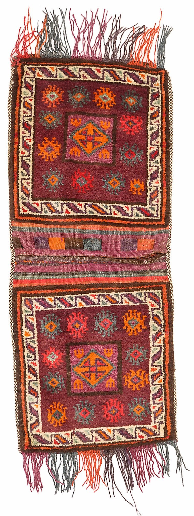A handmade vintage Afghan wool saddle bag featuring geometric patterns in deep red and orange tones.