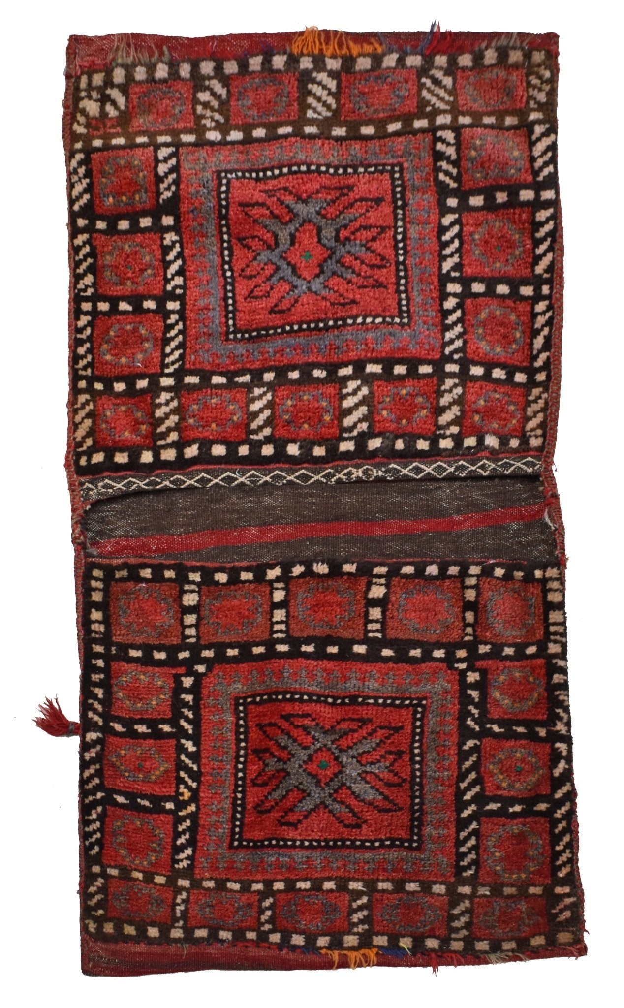 A vintage handmade Afghan wool saddle bag featuring geometric red and black tribal patterns.
