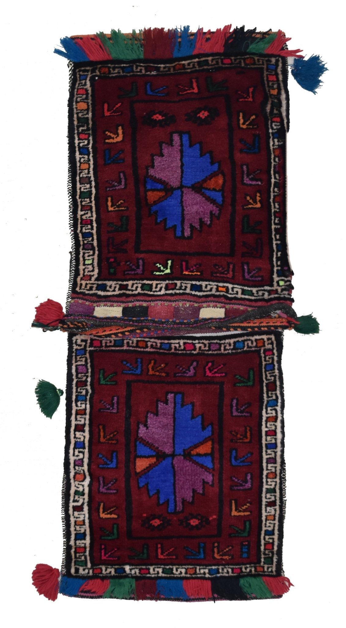 A handmade vintage Afghan wool saddle bag featuring two matching panels with geometric motifs.