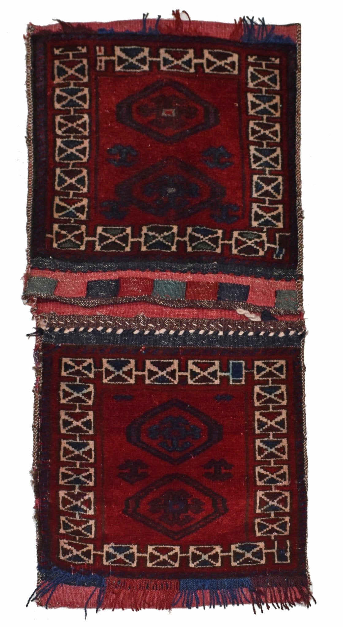 A vintage handmade Afghan wool saddle bag featuring two red panels with geometric diamond motifs.