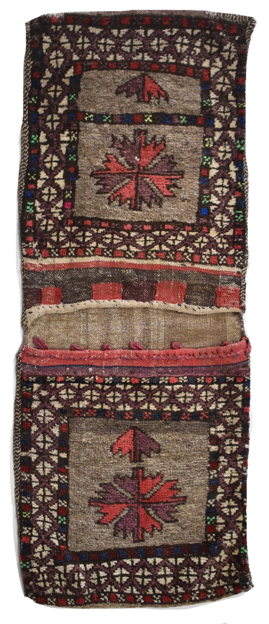 A handmade vintage Afghan wool saddle bag featuring two panels with geometric floral motifs.