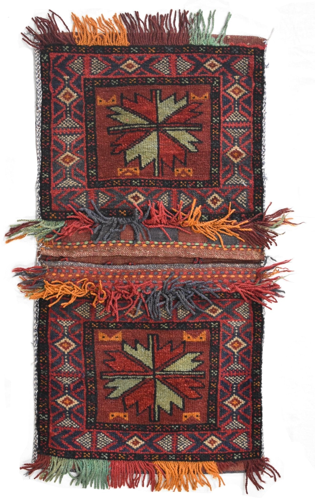 A vintage handmade Afghan wool saddle bag featuring two panels with geometric floral motifs.