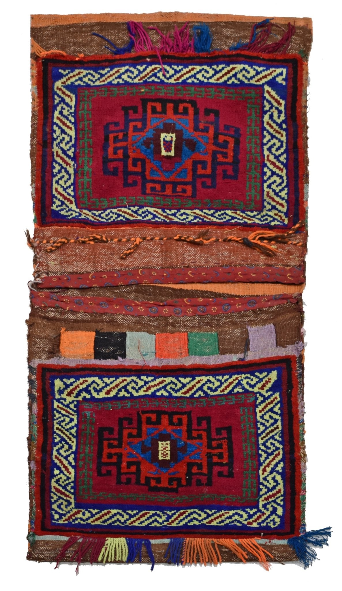 A handmade vintage Afghan wool saddle bag featuring two matching red panels with geometric patterns.