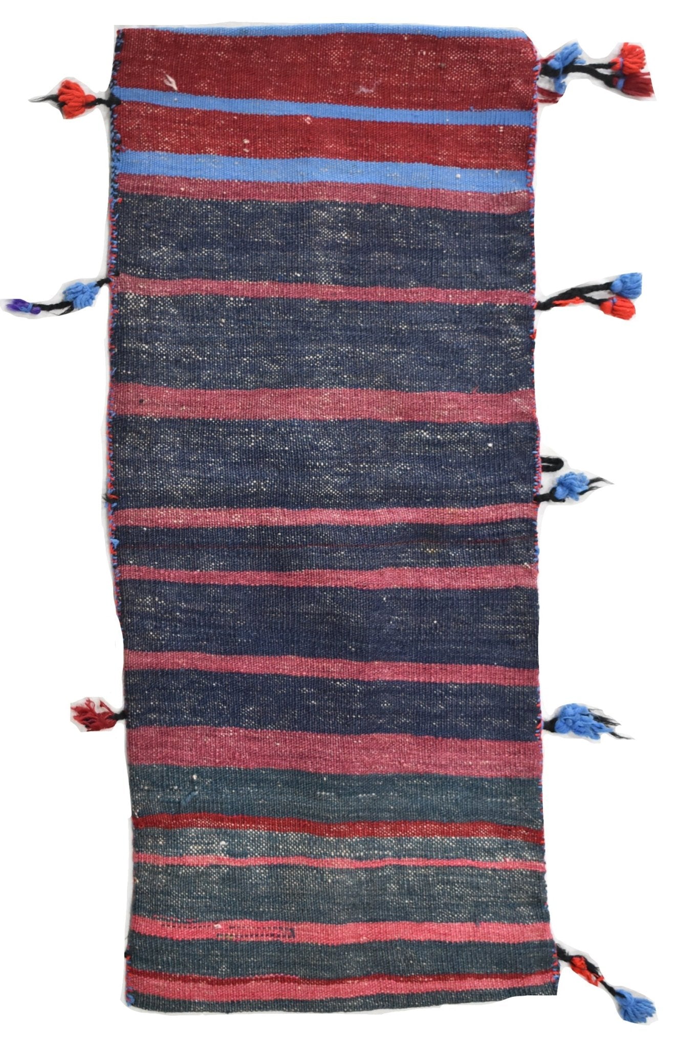 A vintage handmade Afghan wool saddle bag featuring horizontal stripes and decorative side tassels.