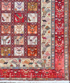A handmade vintage Afghan Sumak kilim featuring geometric bird motifs in red and cream tones.