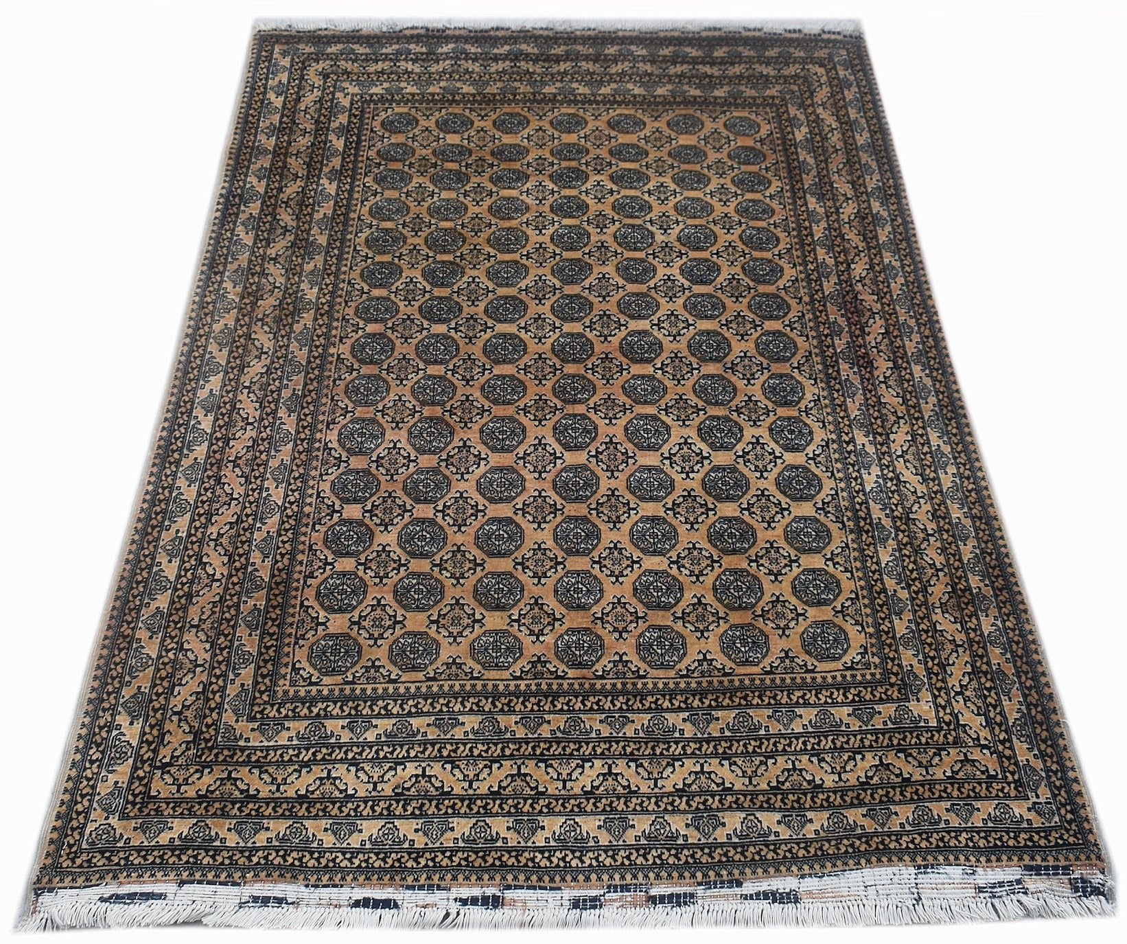 A vintage Afghan Turkmen rug featuring a repeating geometric pattern in black on a tan background.