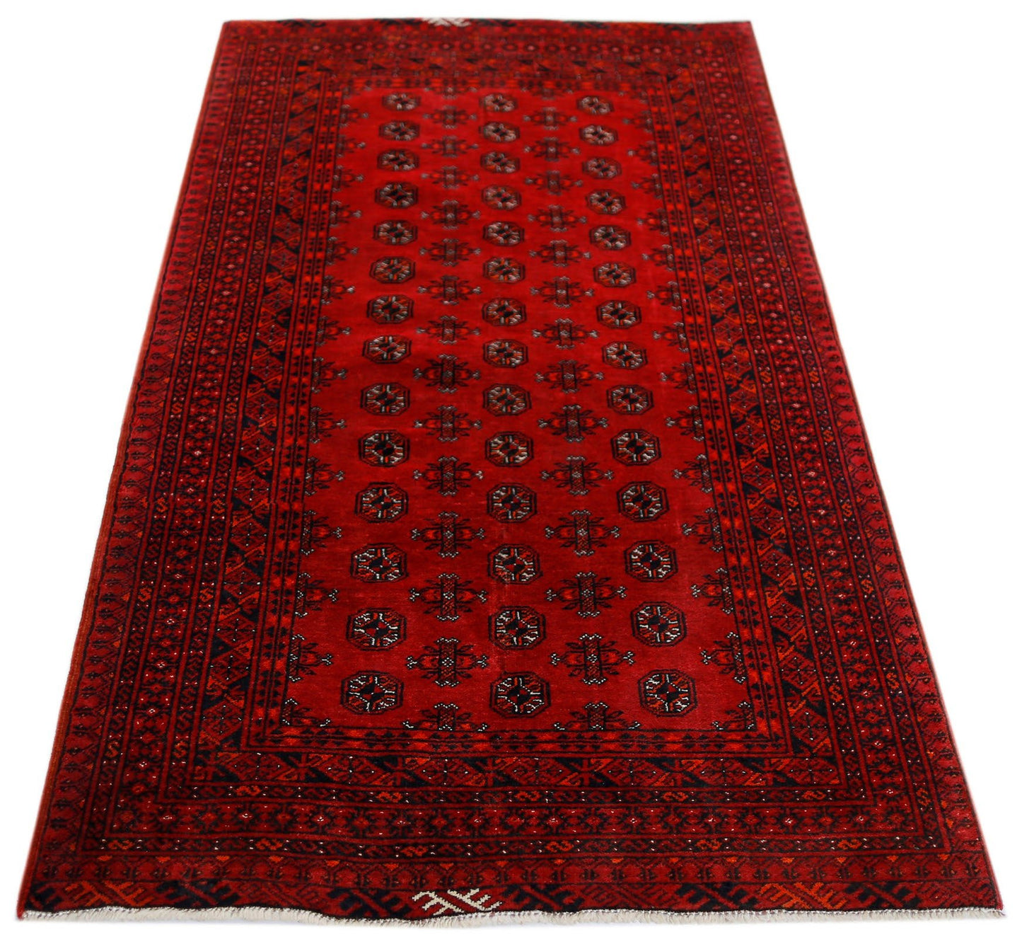 A vintage handwoven Afghan Turkmen rug featuring a repeating geometric pattern in deep red wool.