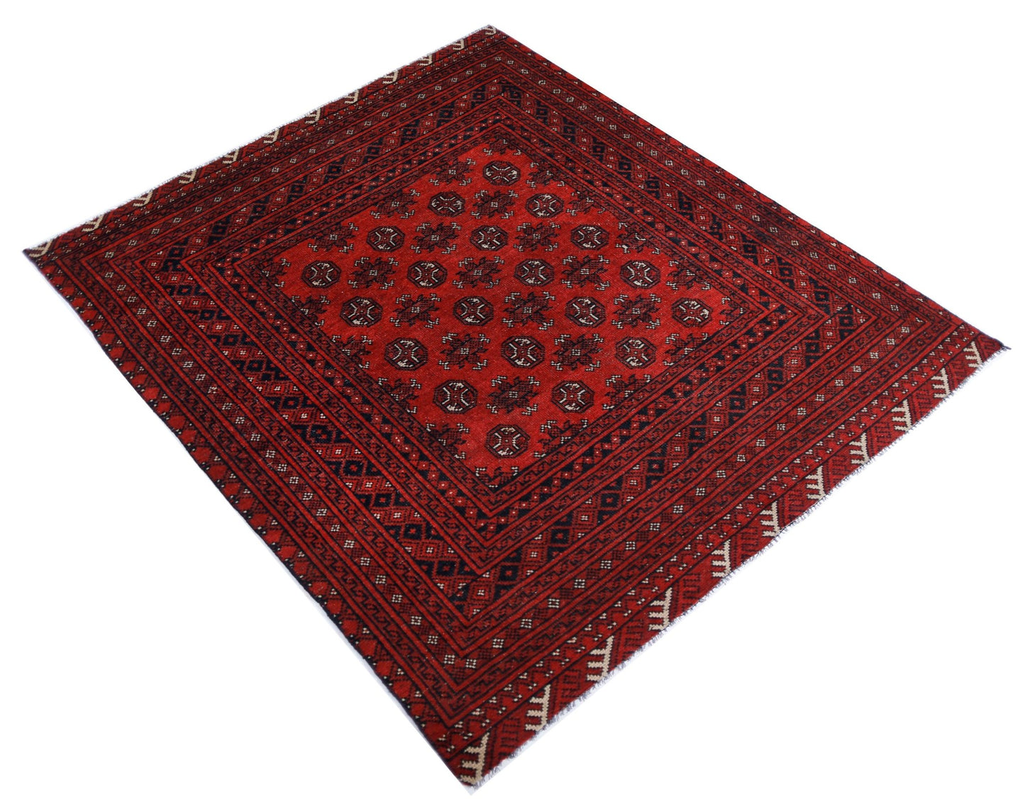 A vintage handwoven Afghan Turkmen rug featuring a repeating geometric pattern in red and black.