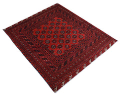 A vintage handwoven Afghan Turkmen rug featuring a repeating geometric pattern in red and black.