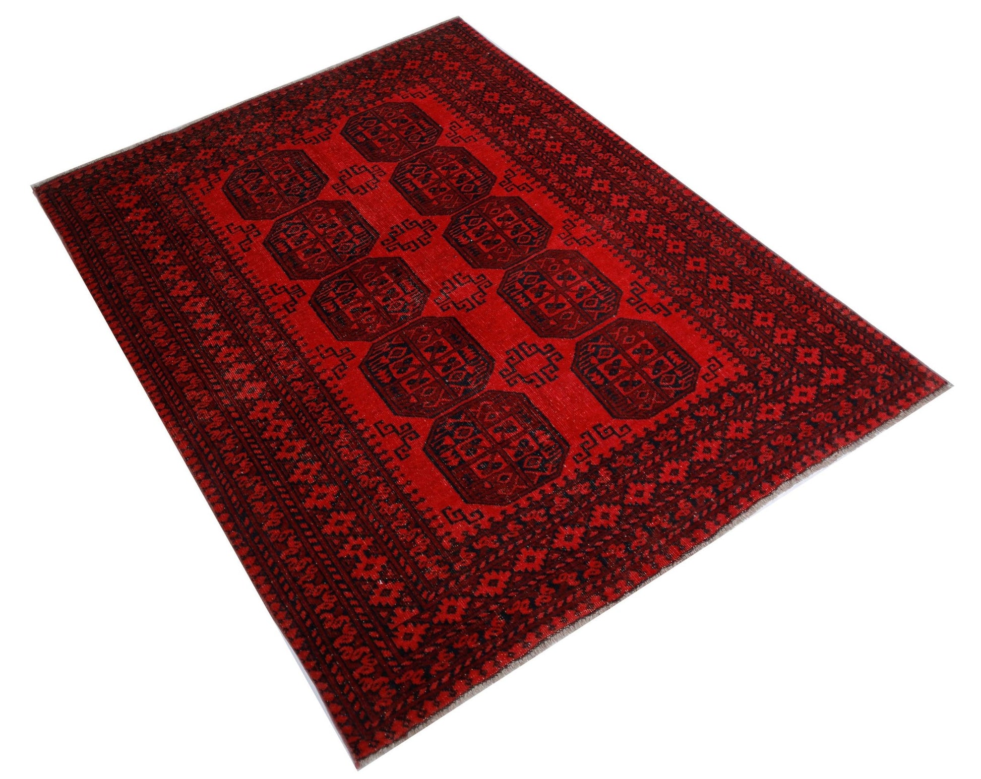A handwoven vintage Afghan Turkmen rug featuring a repeating octagonal gul pattern in red and black.