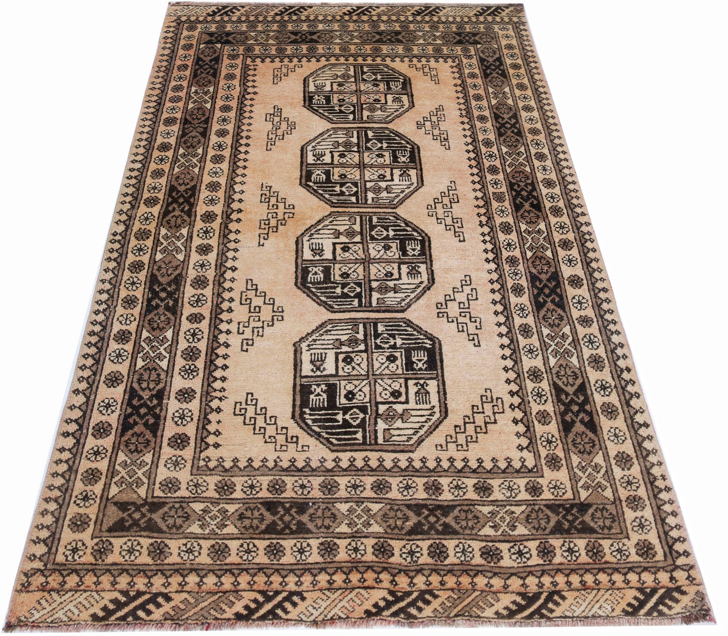A vintage Afghan Turkmen rug featuring four geometric octagonal medallions on a tan wool field.