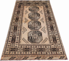 A vintage Afghan Turkmen rug featuring four geometric octagonal medallions on a tan wool field.