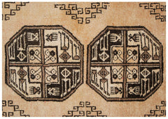 A vintage Afghan Turkmen rug featuring geometric octagonal motifs in dark brown on a natural wool background.
