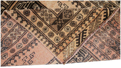 A vintage Afghan Turkmen rug with a folded corner showing intricate geometric patterns in wool.