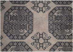 A vintage Afghan Turkmen rug featuring a repeating geometric pattern in shades of grey and brown.