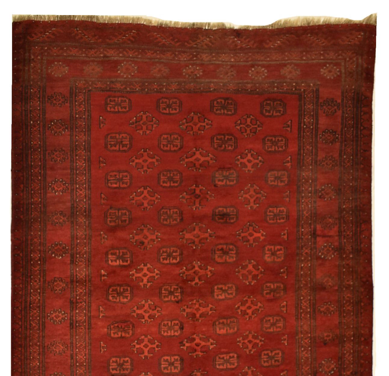 A vintage handmade Afghan Turkmen wool rug featuring a repeating geometric pattern in deep red.