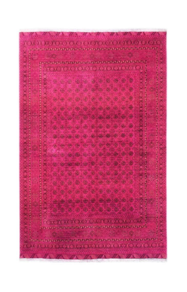 A vintage handmade Afghan Turkmen rug featuring a repeating elephant foot motif in vibrant pink.