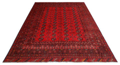 A vintage handmade Afghan Turkmen rug featuring a deep red field with repeating geometric motifs.