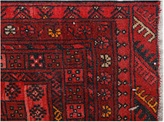 A vintage handmade Afghan Turkmen rug featuring a geometric pattern in deep red and black tones.