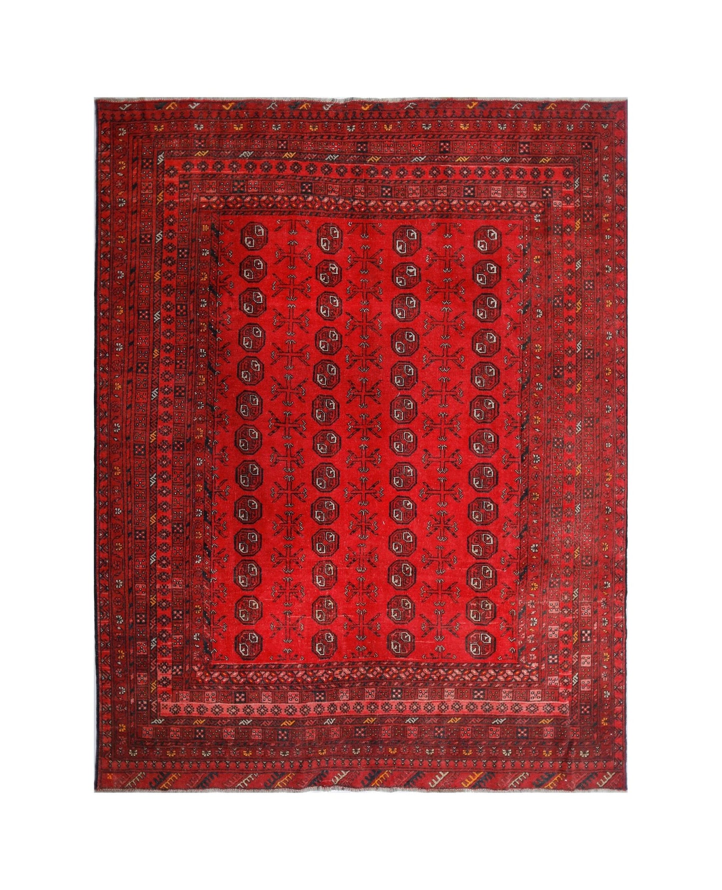 A vintage handmade Afghan Turkmen rug featuring a red field with repeating geometric motifs.