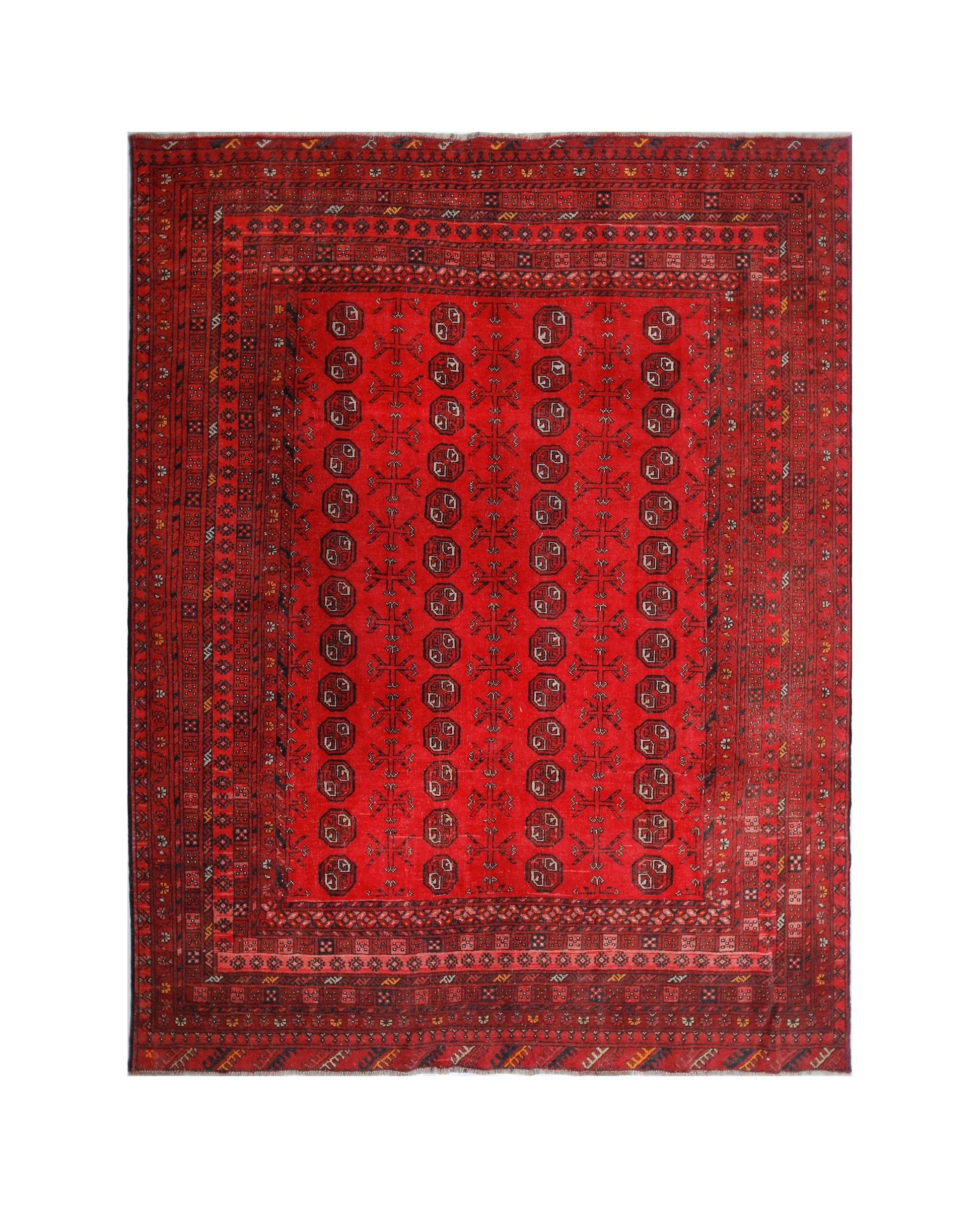 A vintage handmade Afghan Turkmen rug featuring a red field with repeating geometric motifs.